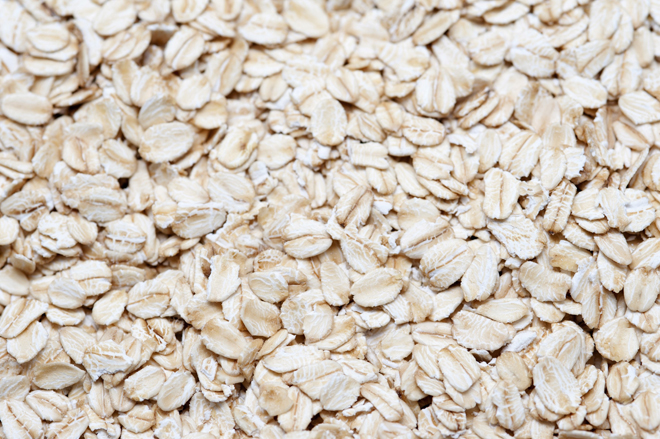 Background of rolled oats, a grain cereal in which the seeds have been milled and rolled for use as a cooking ingredient and breakfast cereal